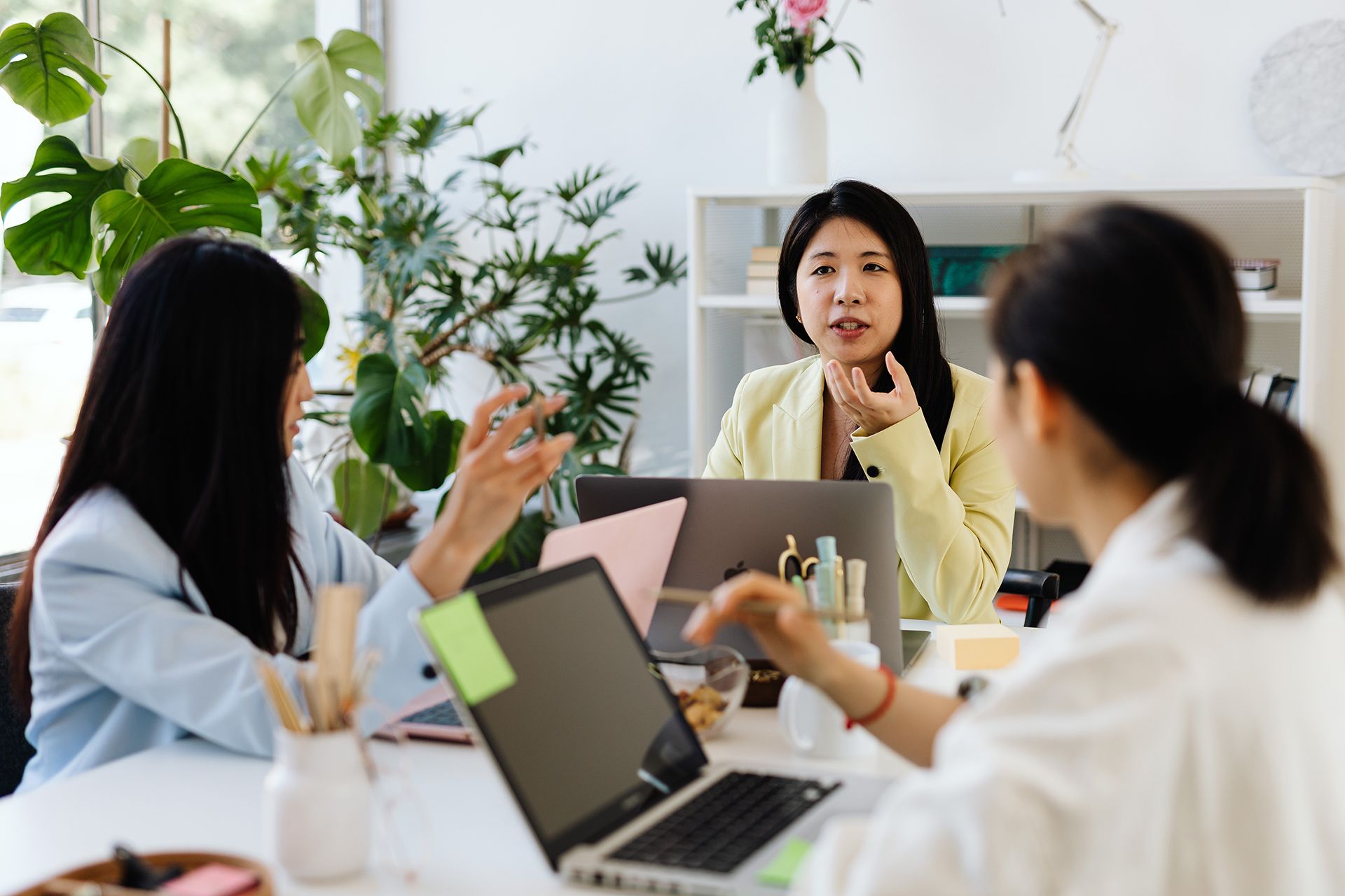 Asian women discussing business in the office